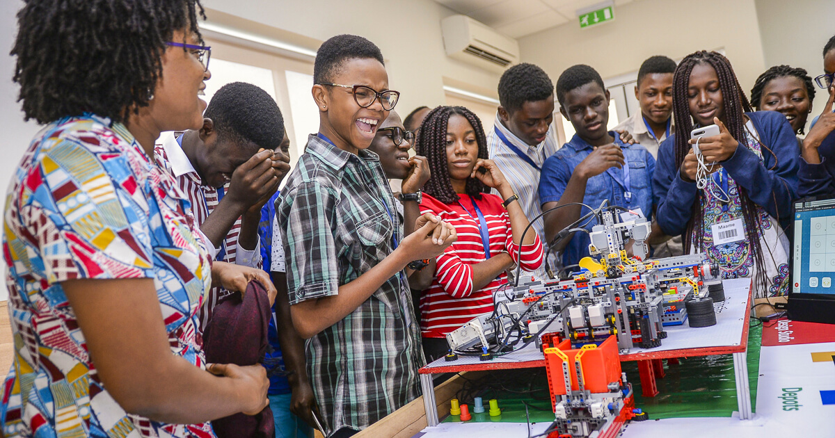 Lecturer engaging with students in Robotics class 